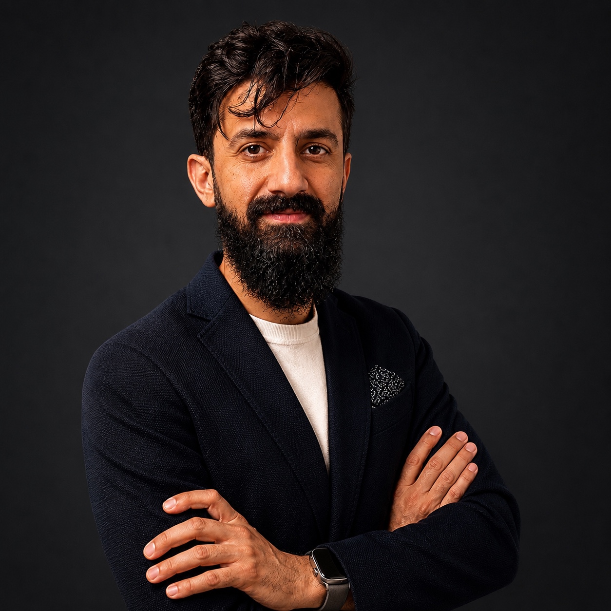 Ehab Omaro wearing a navy blazer, artist and founder of Unfolded Artists
