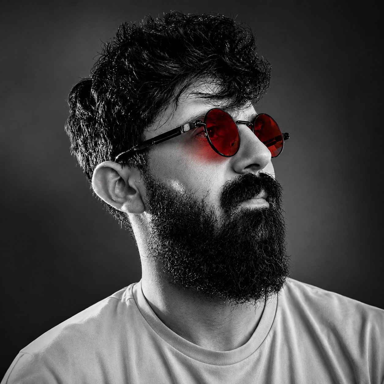 Ehab Omaro in black and white with red round glasses